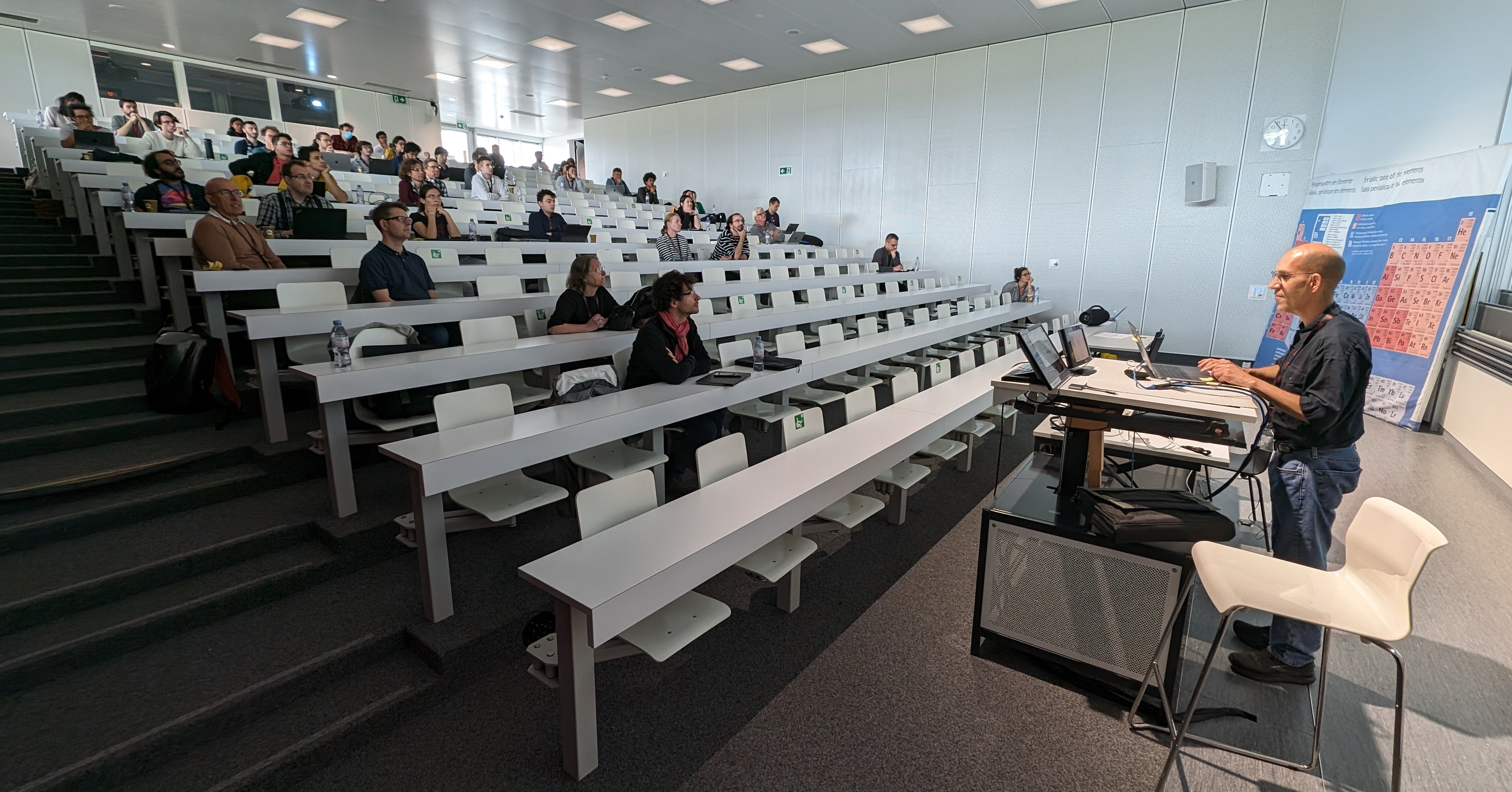 Auditorium with meeting participants. Speaker at the podium giving the talk.